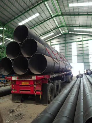 Rear view of stacked steel pipes on a trailer inside the warehouse